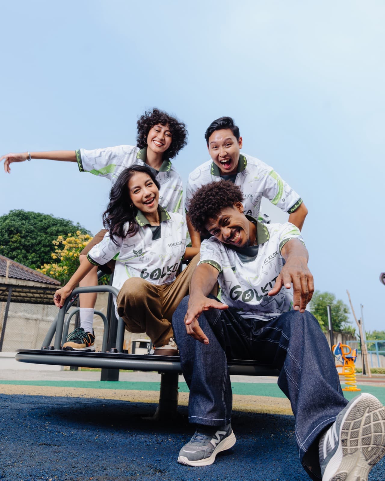 Four people wearing Gol Kita jerseys in a park
