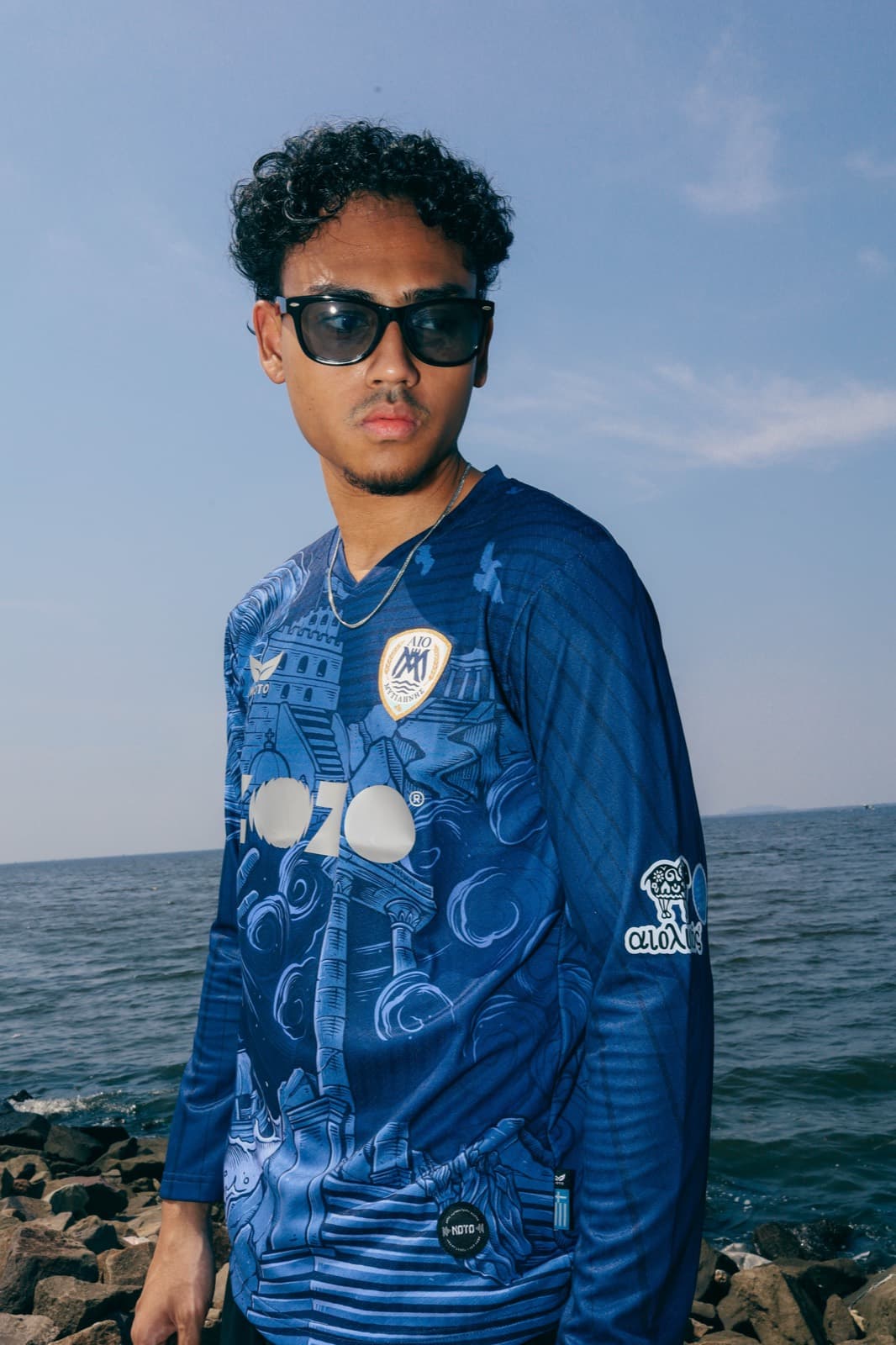 Model wearing the long-sleeved blue AIO Mytilinis jersey