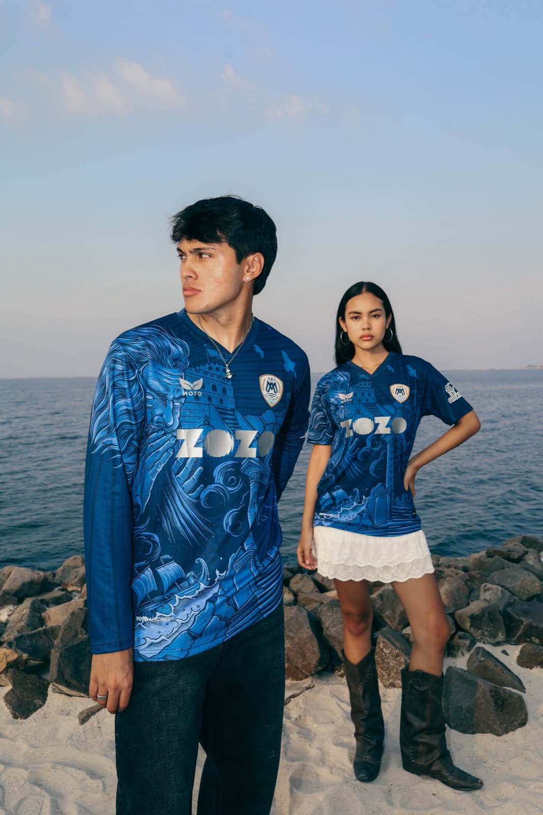 Two people wearing blue AIO Mytilinis jerseys