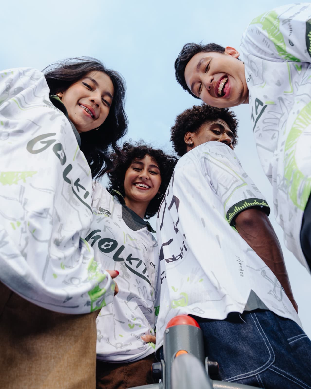 Four people in Gol Kita jerseys photographed from below