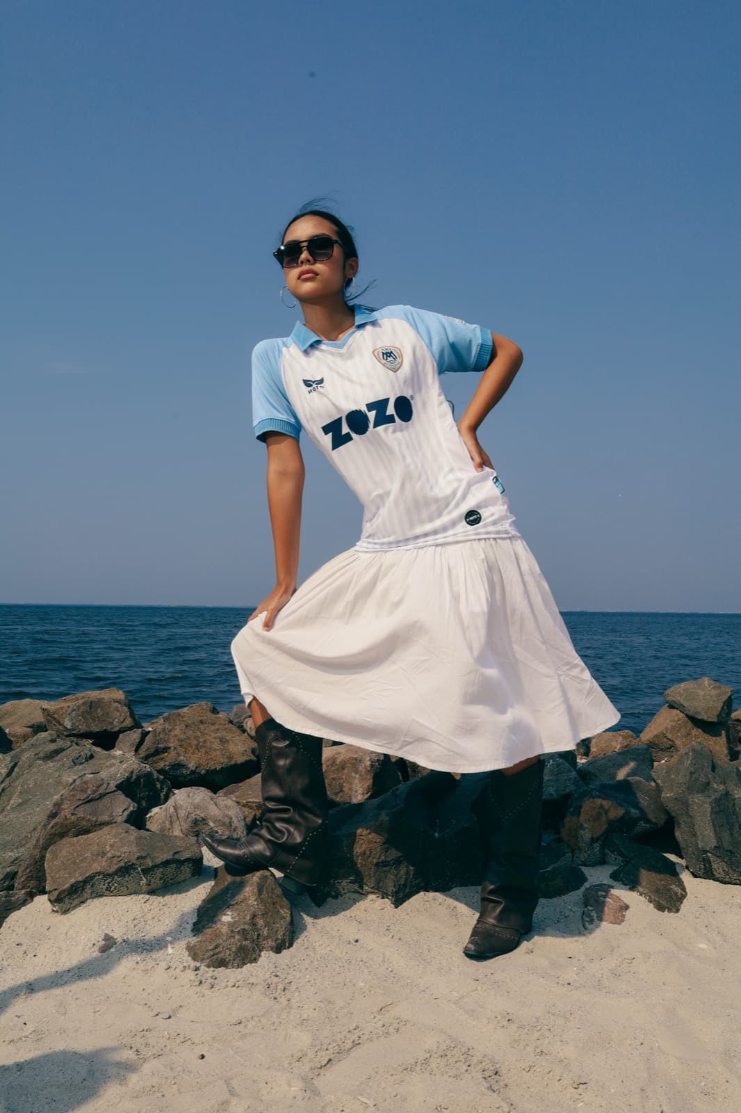 Model in an AIO Mytilinis jersey standing on rocks
